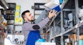 Man worker going through sanitary engineering details in workshop Royalty Free Stock Photo