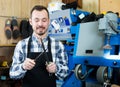 Man worker honing his tools for repairing Royalty Free Stock Photo