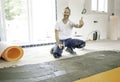 Man worker install orange roll membrane waterproofing on the floor Royalty Free Stock Photo