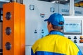 Man worker in manufacturing plant at cable factory machine control computer panel Royalty Free Stock Photo