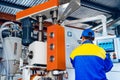 Man worker in manufacturing plant at cable factory machine control computer panel Royalty Free Stock Photo