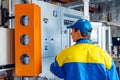 Man worker in manufacturing plant at cable factory machine control computer panel Royalty Free Stock Photo