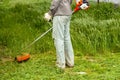 Man  worker mowing grass with trimmer Royalty Free Stock Photo