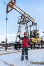 Man worker in the oilfield. Winter period.