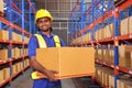 A man worker packing cardboard box with tape gun dispenser in warehouse Royalty Free Stock Photo