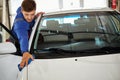 Man worker polishing car on a car wash Royalty Free Stock Photo