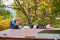 Man worker prepearing for mounting photovoltaic solar modules on roof of house. Royalty Free Stock Photo