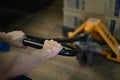 Man worker pulling hand pallet truck with cardboard package boxes in distribution warehouse. Royalty Free Stock Photo