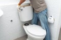 Man worker repairing with toilet tank in bathroom, Royalty Free Stock Photo