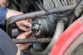Man worker repairs motorcycle carburetor