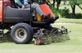 Man Worker riding mower machine cutting fairway. Royalty Free Stock Photo