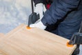 A man a worker secures the chipboard panels with two clamps