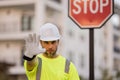 Man in worker uniform and hardhat with open hand doing stop sign with serious and confident expression, defense gesture Royalty Free Stock Photo