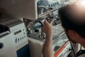 Man worker in uniform inspecting coffee machine in own workshop Royalty Free Stock Photo