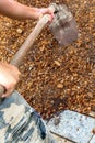 Man worker using hoe equipment on the soil clay dirt Royalty Free Stock Photo