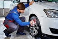 Man worker washing car`s alloy rims on a car wash