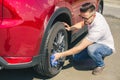 Man worker washing car`s alloy wheels on a car wash. Car wash with soap. Royalty Free Stock Photo