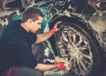 Man worker washing car's alloy wheels Royalty Free Stock Photo