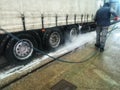 Man worker washing a semi trailer Royalty Free Stock Photo