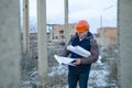 The man worker wear a orange helmet with construction site Royalty Free Stock Photo