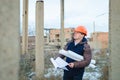 The man worker wear a orange helmet with construction site Royalty Free Stock Photo