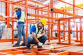 Man worker welder welding steel structures inside buildings of industrial plants in construction site. Male technician working Royalty Free Stock Photo