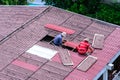 Man workers replacing damaged old tiles roof