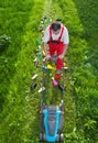 Man working against nature - concept with plastic spewing lawn m