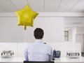 Man Working Alone Beside Balloon In Office