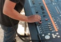 Man working with analogue sound mixing table