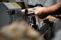 a man in a working apron works on a wood turning lathe. Royalty Free Stock Photo