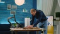 Man working as architect analyzing building model and layout Royalty Free Stock Photo