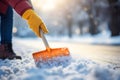 A man working as a janitor diligently shovels snow from the road