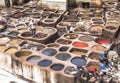 Man working as a tanner in the dye pots at leather tanneries at medina, Fes el Bali, in Fez, Morocco. Royalty Free Stock Photo