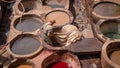 Man working as a tanner in the dye pots at leather tanneries at medina, Fez, Morocco. Royalty Free Stock Photo