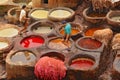 Man working as a tanner in the dye pots at leather tanneries viewed from from the Terrace de Tanneurs in the ancient Fez medina, Royalty Free Stock Photo