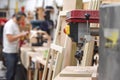 Man working in background of a carpentry workshop with tools Royalty Free Stock Photo