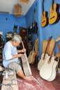 Man working on building a hand made guitar at Yogyakarta