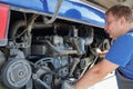A man is working on a bus engine Royalty Free Stock Photo