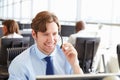 Man working in a call centre,holding headset, close-up Royalty Free Stock Photo