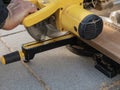 Man working with circular blade saw for cutting wood beam. Royalty Free Stock Photo