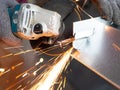 Man is working with a circular saw. Sparks fly from hot metal. Royalty Free Stock Photo