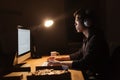 Man working with computer and eating pizza in dark office Royalty Free Stock Photo