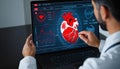 Man working on computer with heart on screen, closeup. Cardiology concept