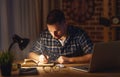 Man working on computer at home at night in dark Royalty Free Stock Photo