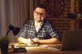 Man working on computer at home at night in dark Royalty Free Stock Photo