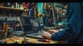 A man is working on a computer in a workshop AIG41 Royalty Free Stock Photo