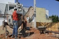 Man, construction worker using cement mixer, Brazil, south America , panoramic photo, Royalty Free Stock Photo