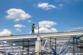 Man working on construction site with scaffold and building with sky background,scaffolding for construction factory Royalty Free Stock Photo