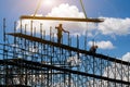 Man working on construction site with scaffold and building with sky background,scaffolding for construction factory